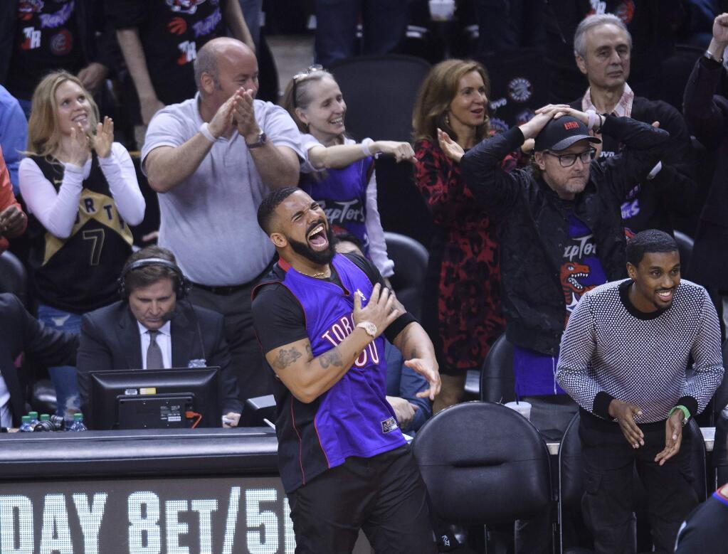 Rapper Drake reacts courtside as the Toronto Raptors play against the Golden State Warriors during the first half of Game 1 of basketball's NBA Finals, Thursday, May 30, 2019, in Toronto. (Nathan Denette/The Canadian Press via AP)