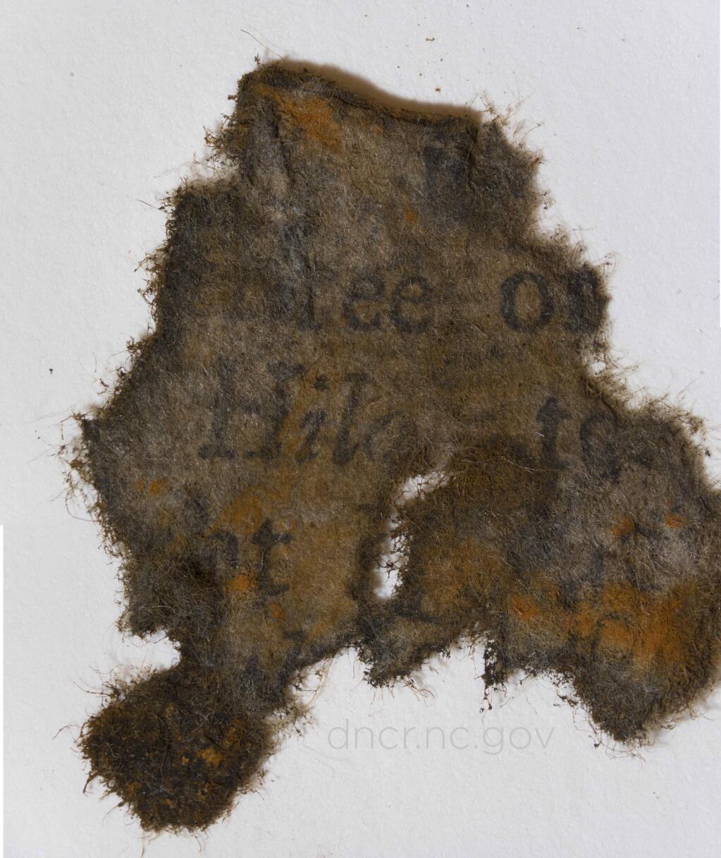 This undated photo made available by the North Carolina Department of Natural Resources shows a piece of paper from books found on board Blackbeard's ship the Queen Anne's Revenge. To find paper in the 300-year-old shipwreck in warm waters is 'almost unheard of,' said Erik Farrell, a conservator at the QAR Conservation Lab in Greenville. (North Carolina Department of Natural and Cultural Resources via AP)