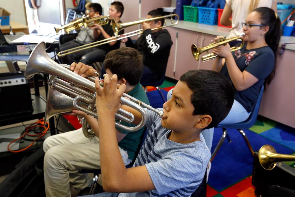 Sixth grader Feliciano Rascon, 11,and his classmates try to blow notes through their brass instruments for the first time during the music blitz program at Luther Burbank Elementary School in Santa Rosa, California, on Thursday, September 13, 2018. (Alvin Jornada / The Press Democrat)