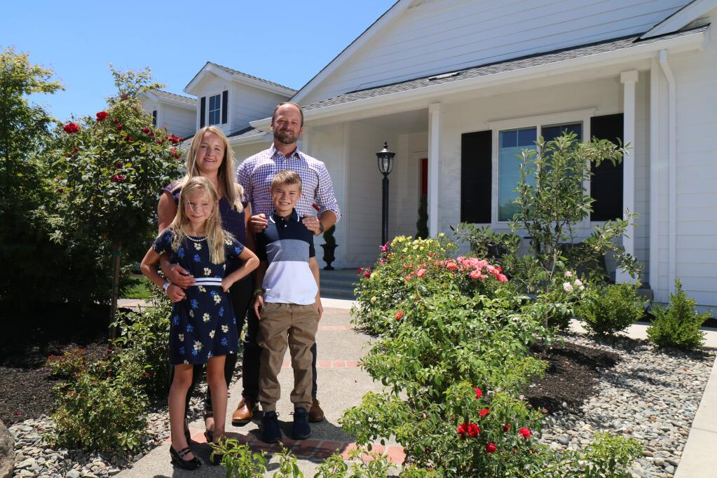 Brandy and Brad Sherwood stand with their children outside their rebuilt Larkfield Estates home in north Santa Rosa on Tuesday, June 2, 2020. Their home was destroyed along with thousands of others by the Tubbs Fire in October 2017. (Jeff Quackenbush / North Bay Business Journal)