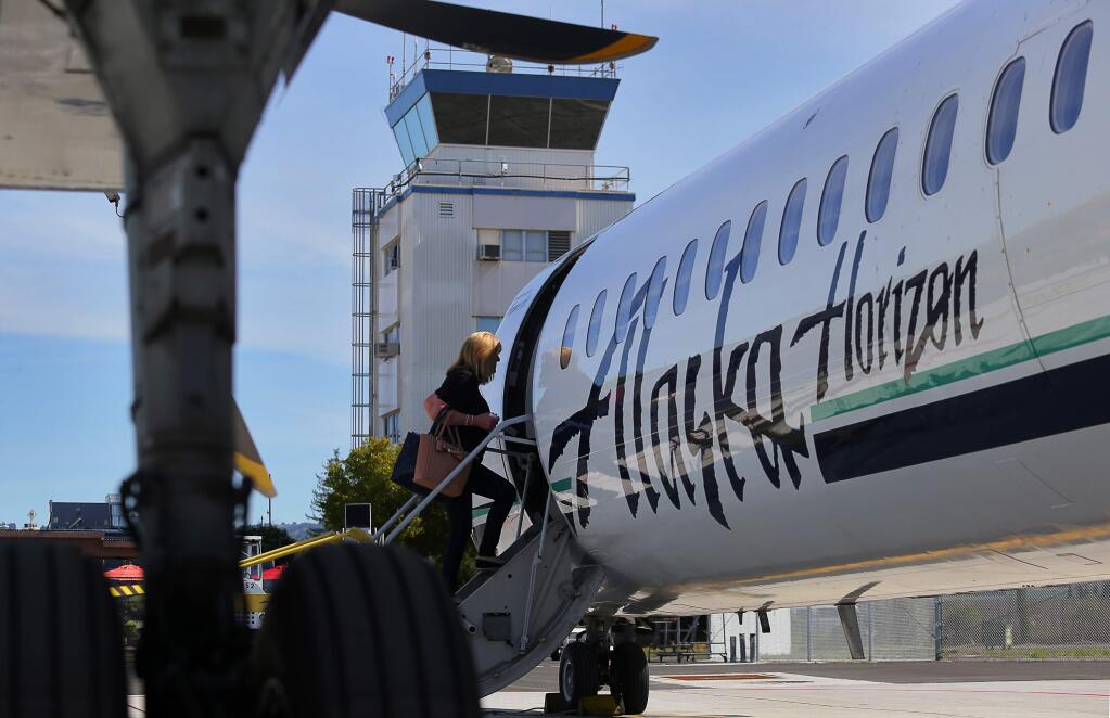A passenger boards the Alaska Airlines inaugural flight to John Wayne Airport, in Orange County, from the Charles M. Schulz-Sonoma County Airport in Santa Rosa, on Wednesday, March 16, 2016. (Christopher Chung/ The Press Democrat)