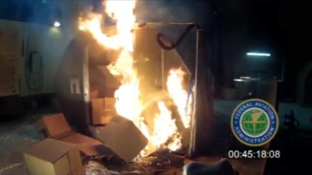 FILE - In this April 2014 file image frame grab from video, provided by the Federal Aviation Administration (FAA), a test at the FAAs technical center in Atlantic City, N.J. The U.S. government is urging that large, personal electronic devices like laptops be banned from airline checked luggage because of the potential for a catastrophic fire. (FAA via AP, File)