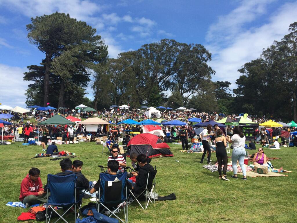 People sit out in Golden Gate Park in the area unofficially known as 'Hippy Hill' in San Francisco on Wednesday, April 20, 2016. People descended on the park to smoke pot for the annual 4/20 celebration, in what may be the last year marijuana is illegal in California. (AP Photo/Haven Daley)