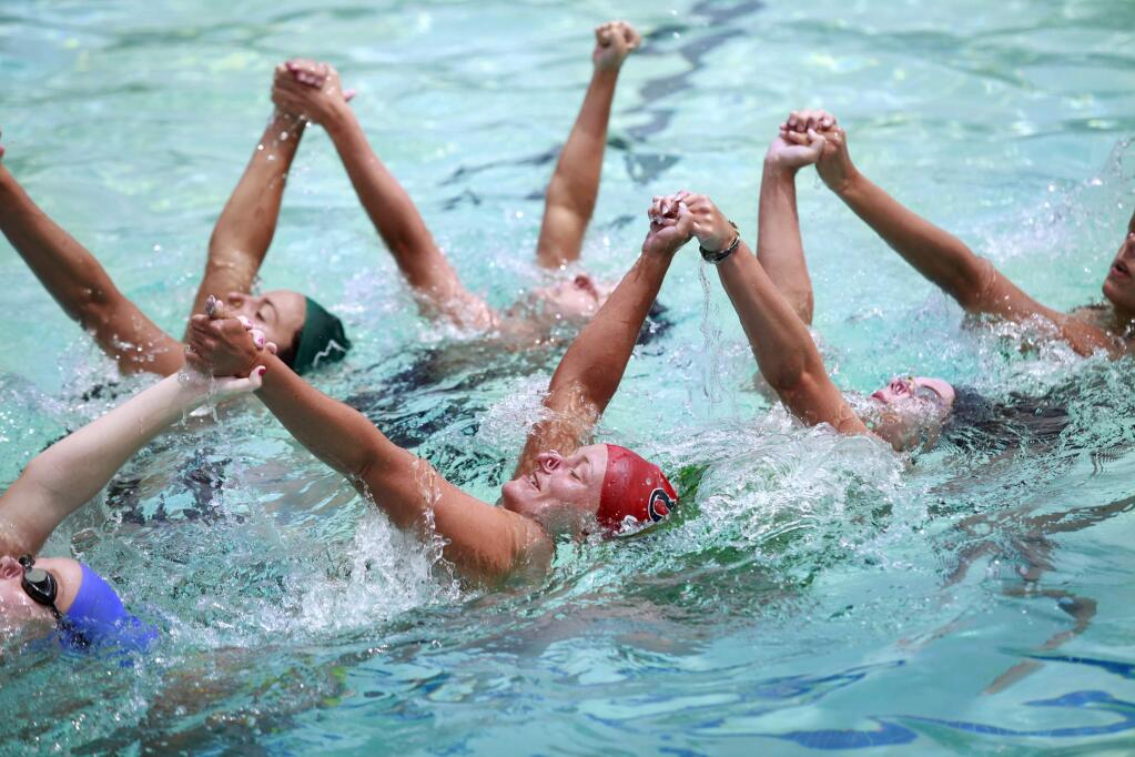 Alex Cox, 22, center, practice one of two routines with members of the senior team at Oak Park Swim and Racquet Club in preparation for the 2014 U.S. Open Synchronized Swimming Championships this week in Henderson, Nev. Photo taken in Santa Rosa, on Tuesday, July 15, 2014. (BETH SCHLANKER/ The Press Democrat)