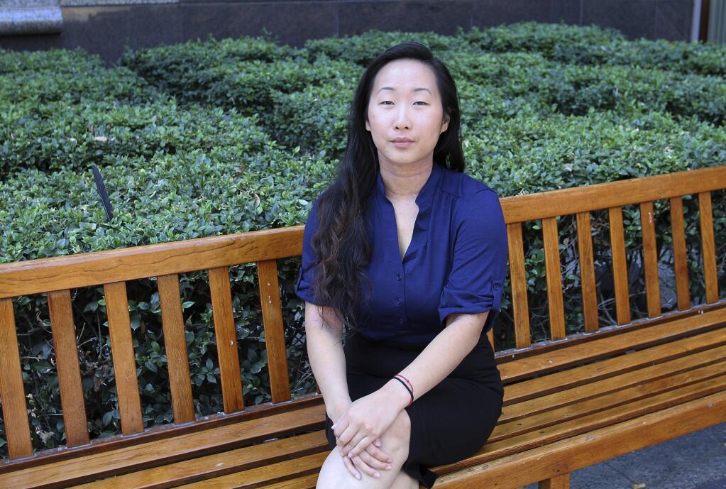 FILE - In this Aug. 12, 2016, file photo, Yee Xiong, 24, sits for a photo in Sacramento, Calif. A Northern California judge has dismissed a $4 million defamation lawsuit against Yee Xiong who says she was raped by a man four years ago. Attorney McGregor Scott says that the judge on Monday, Oct. 4, 2016, dismissed the suit filed by Lang Her, a former UC Davis student who is being held at the Yolo County jail, for assaulting Yee Xiong at a party in July, 2012. (AP Photo/Darcy Costello, file)