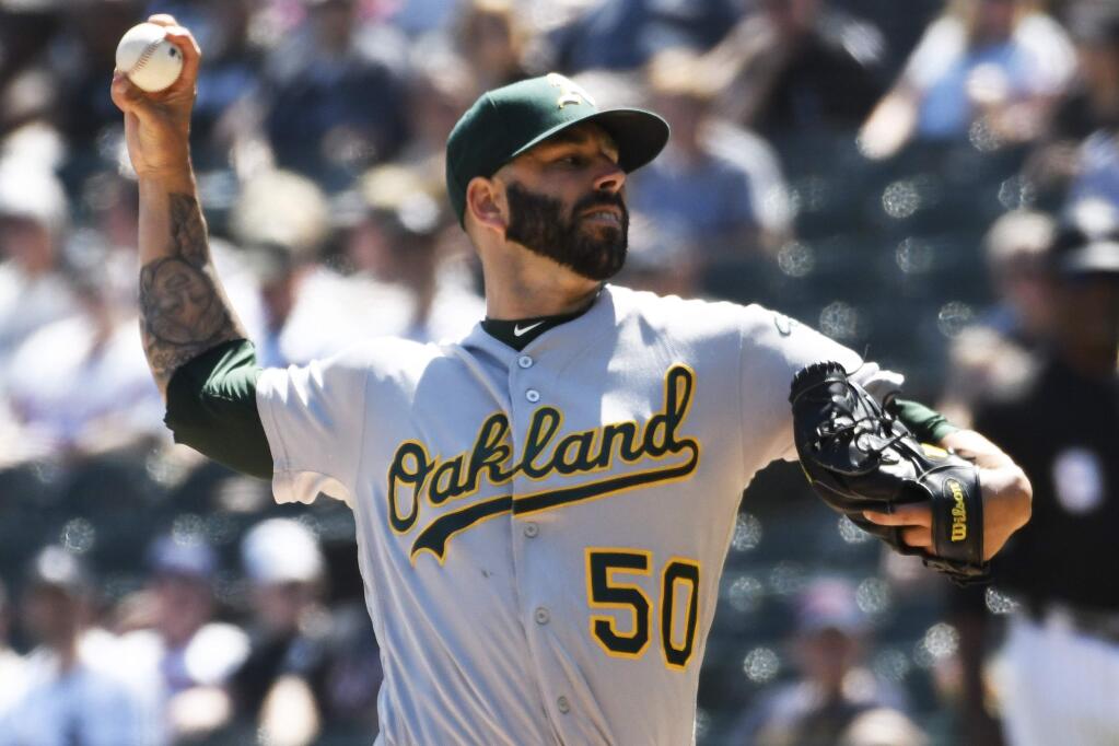 Oakland Athletics starting pitcher Mike Fiers (50) throws the ball against the Chicago White Sox during the first inning of a baseball game, Friday, Aug. 9, 2019, in Chicago. (AP Photo/David Banks)