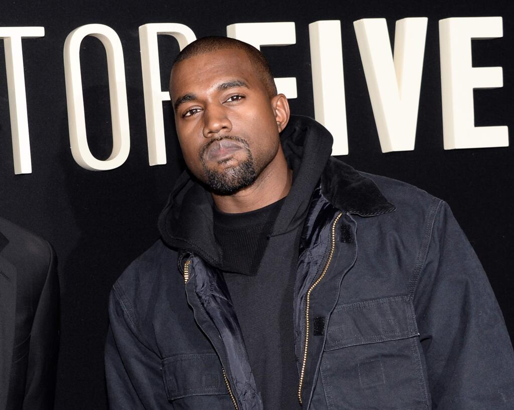 FILE - In this Dec. 3, 2014 file photo, Kanye Wests attend the premiere of 'Top Five' at the Ziegfeld Theatre in New York. West paid a visit on Ryan Seacrest and his 'On Air' radio show Wednesday, Feb. 11, 2015, to expound on his post-Grammy diss of the Album of the Year winner, Beck. The rapper walked up the steps at the Staples Center in Los Angeles as Beck was accepting his award Sunday night but retreated. During an aftershow on E!, West ranted that Beck should 'respect artistry' and turn over his statue to fellow nominee Beyonce. West told Seacrest of his stair-climbing antics: 'It was kind of a joke like the Grammys themselves.' (Photo by Evan Agostini/Invision/AP, File)