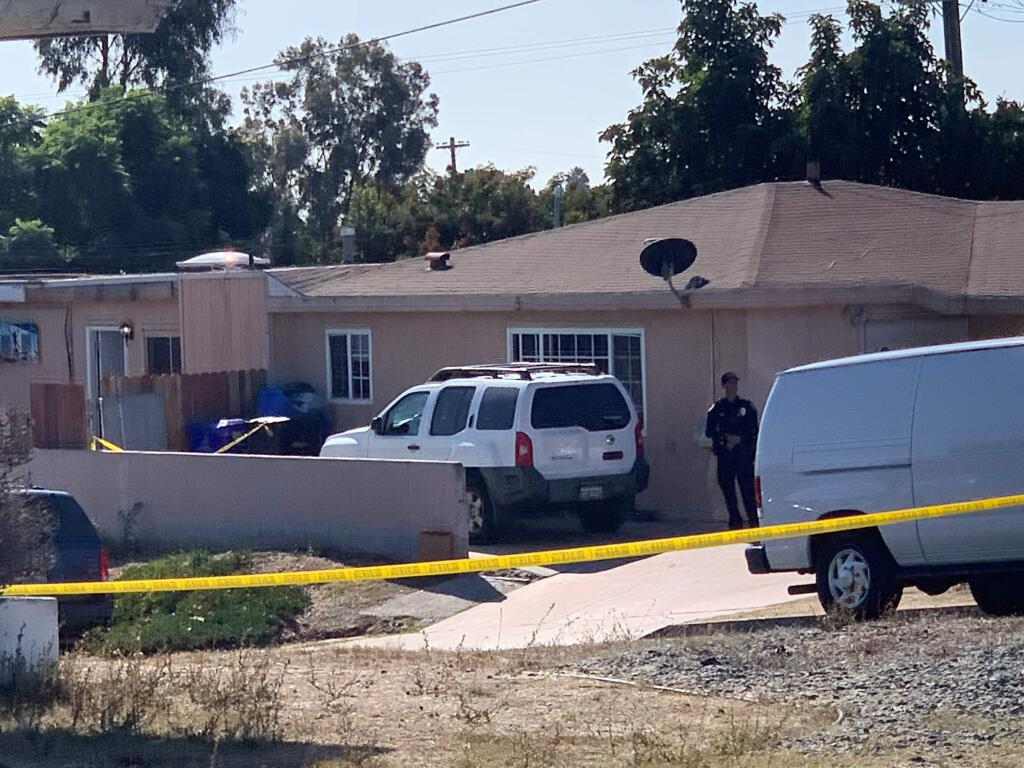 San Diego police investigate a shooting that killed five members of a family and wounded one more in Paradise Hills on Saturday, Nov. 16, 2019 in San Diego, Calif. Police said two adults and three children were shot to death and a fourth child was hospitalized with injuries in an apparent murder-suicide in San Diego. (Hayne Palmour/The San Diego Union-Tribune via AP)