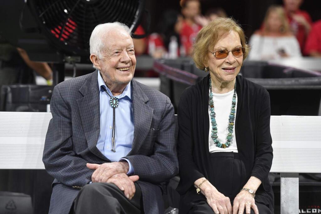 FILE- In this Sept. 30, 2018 file photo, former President Jimmy Carter and Rosalynn Carter are seen ahead of an NFL football game between the Atlanta Falcons and the Cincinnati Bengals, in Atlanta. Former President Carter turns 95 on Tuesday, Oct. 1, 2019. (AP Photo/John Amis, File)