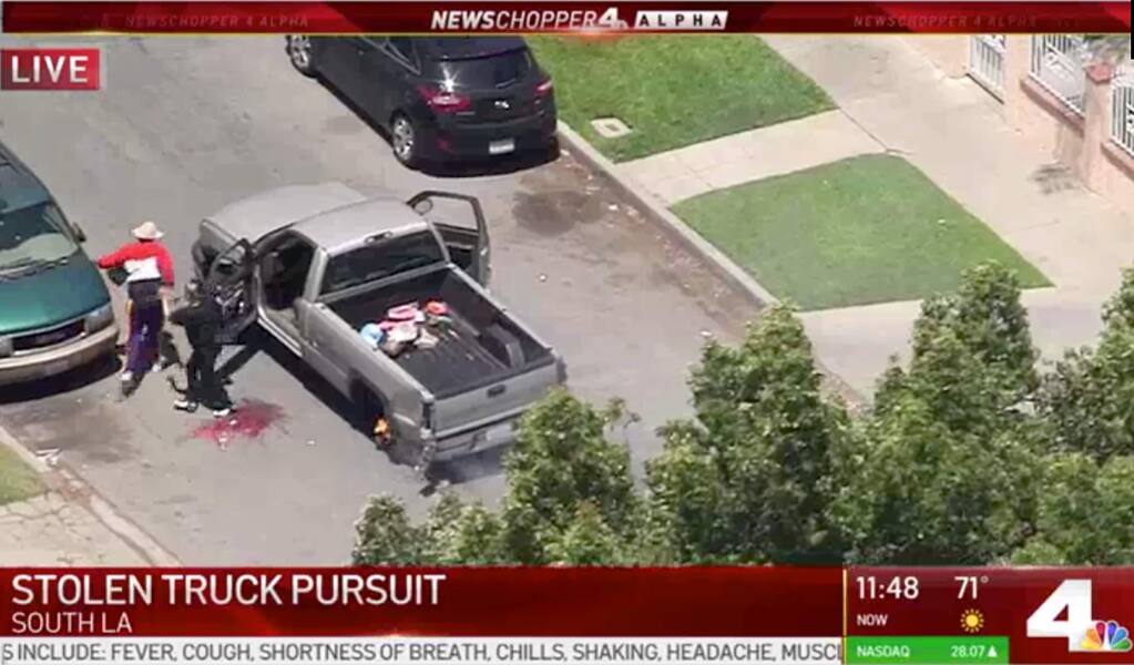This May 22, 2020, photo from video provided by KNBC-TV shows the end of a pursuit a pickup that had been reported stolen after being pursued by police on Southern California streets and freeways. Two people were taken into custody. The coronavirus hasn't been kind to car owners. With more people than ever staying home to lessen the spread of COVID-19, their sedans, pickup trucks and SUVs are parked unattended on the streets, making them easy targets for opportunistic thieves. Sometimes they're even stolen in broad daylight and lead to high-speed police pursuits. (KNBC-TV via AP)