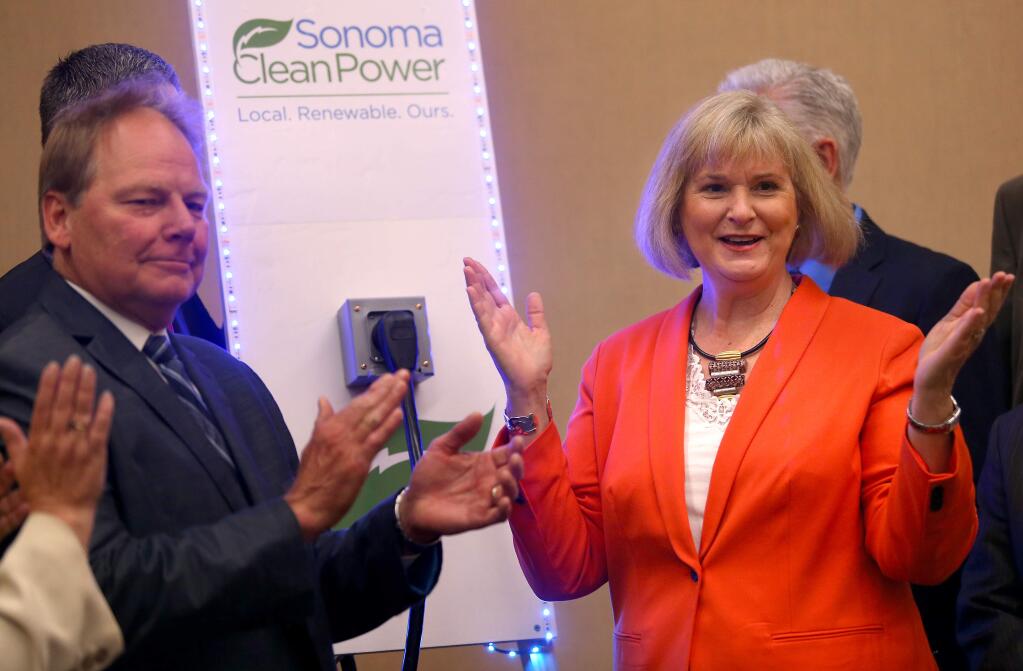 5/2/2014:B1: Sonoma Clean Power board chairwoman Susan Gorin, right, places a plug in a symbolic power outlet to mark the start of the agency's electrical service. At left is Santa Rosa City Councilman Gary Wysocky. PC: Sonoma Clean Power board chair Susan Gorin plugs in a power plug into a symbolic outlet to mark the start of electrical service to homes and businesses during their meeting in Santa Rosa on Thursday, May 1, 2014. (Christopher Chung/ The Press Democrat)