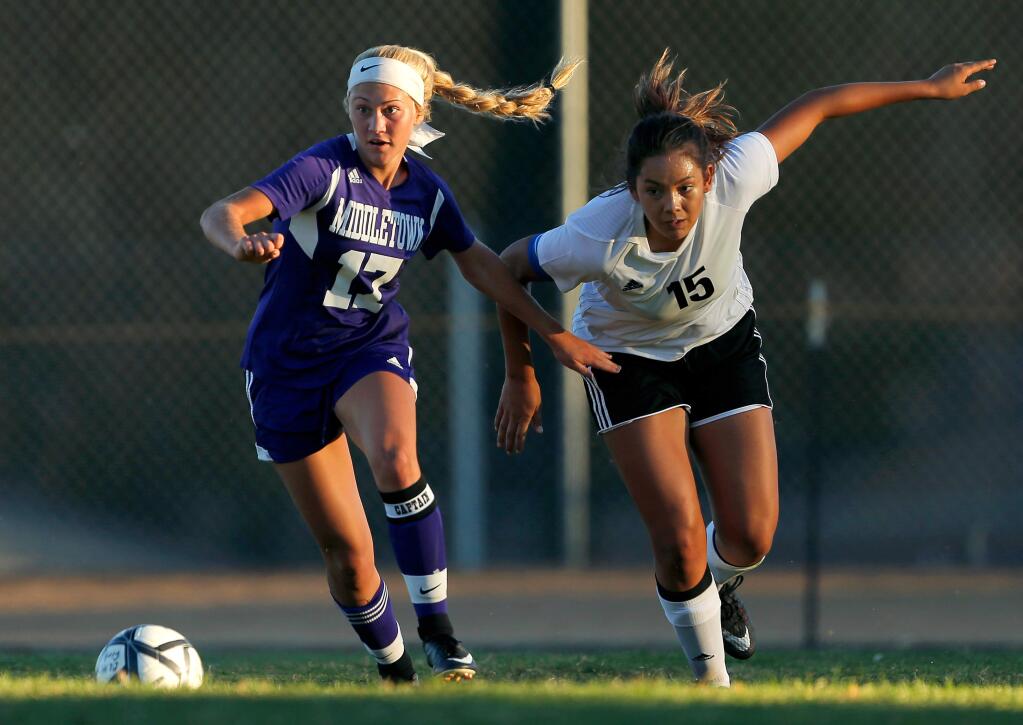 Middletown's Aly Ferguson, left, gets past Clear Lake's Regina Faalelea to score the first goal for the Mustangs during the first half in Lakeport on Tuesday, Sept. 26, 2017. (Alvin Jornada / The Press Democrat)
