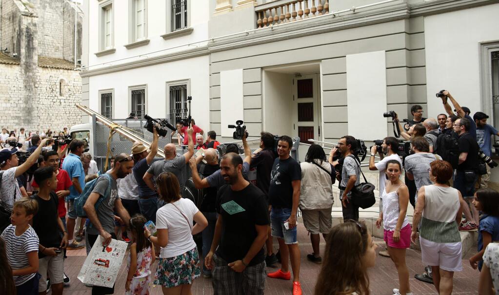 Media take pictures as workers arrive at the Theater Museum in Figueres, Spain, Thursday, July 20, 2017. Salvador Dali's eccentric artistic and personal history took yet another bizarre turn Thursday with the exhumation of his embalmed remains in order to find genetic samples that could settle whether one of the founding figures of surrealism fathered a daughter decades ago. (AP Photo/Manu Fernandez)