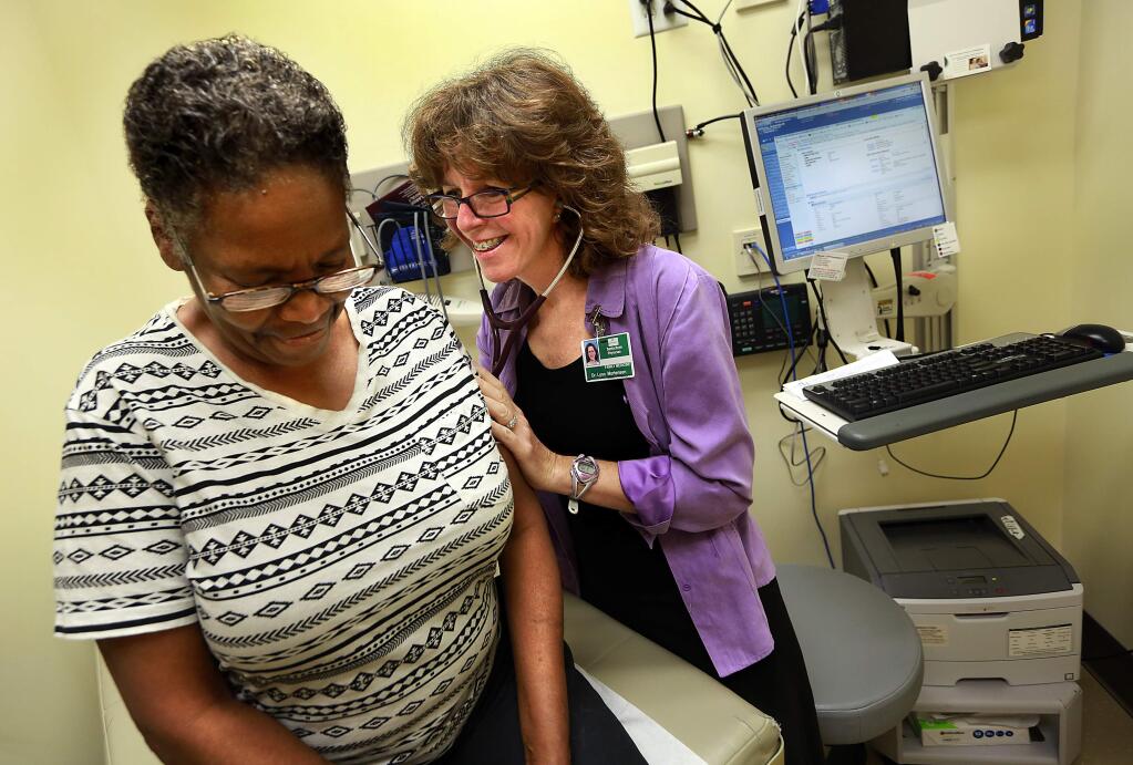 Dr. Lynn Mortensen listens to the lungs of longtime patient Jeannette Anthony of Santa Rosa during a visit to the Kaiser Medical Center in Santa Rosa in 2014. (JOHN BURGESS/ PD FILE)