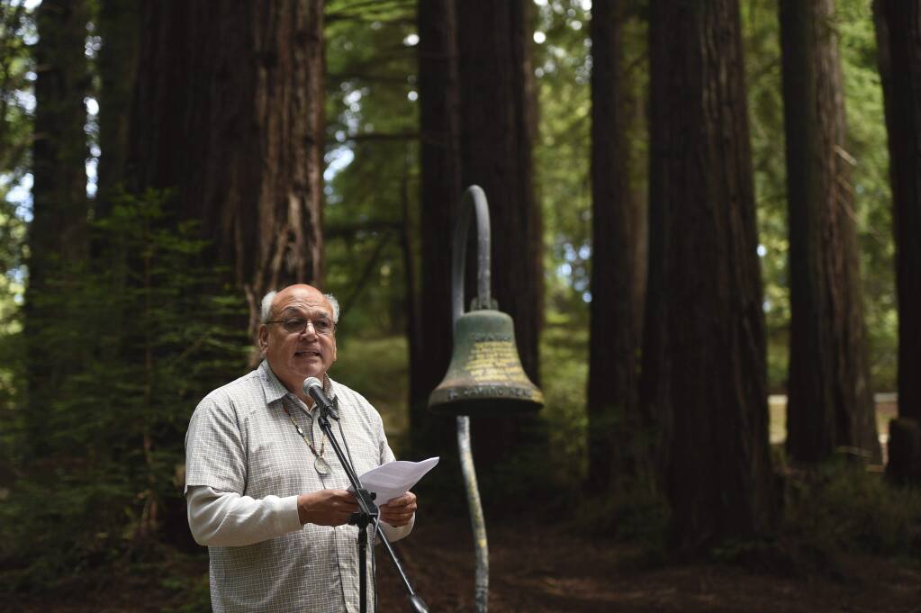 Valentin Lopez, chairman of the Amah Mutsun Tribal Band, speaks in front of an El Camino Real bell marker before it was officially removed from the campus of UC Santa Cruz on Friday, June 21, 2019, in Santa Cruz, Calif. The cast-iron bell marker is one of hundreds in the state which memorializes the California Missions and is viewed by the Amah Mutsun Tribal Band and other California indigenous people as a racist symbol that glorifies the domination of their ancestors. (AP Photo/Cody Glenn)