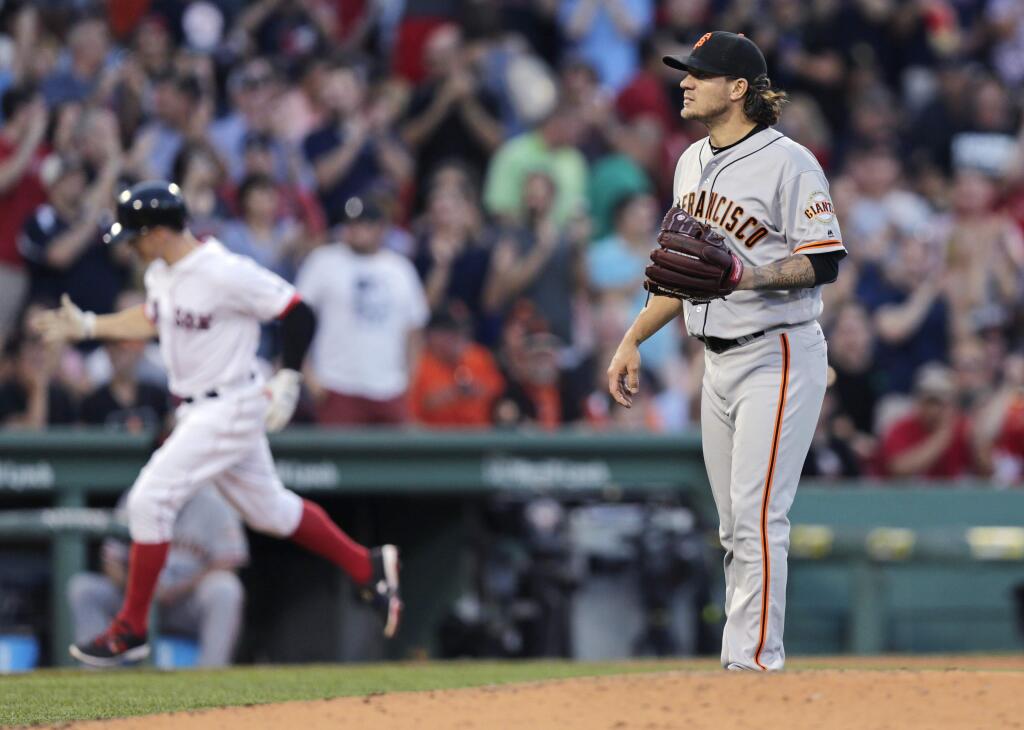 San Francisco Giants starting pitcher Jake Peavy, right, waits for a fresh baseball as Boston Red Sox's Brock Holt, left, rounds third on his solo home run during third first inning of a baseball game at Fenway Park, Tuesday, July 19, 2016, in Boston. (AP Photo/Charles Krupa)
