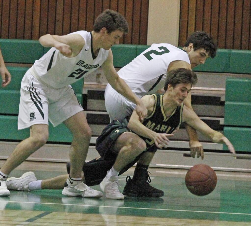Bill Hoban/Index-TribuneSonoma's Riley Phelan (#21) and Tyler Garrett (#2) force a Maria Carrillo player into giving up the ball in a recent game. Tuesday, the Dragons broke open a close game and beat Napa, 53-43. Sonoma hosts San Rafael Saturday evening. Game time is 7:30 p.m.