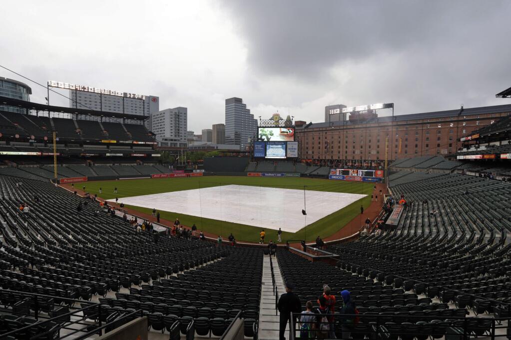 Storm clouds roll over Oriole Park at Camden Yards before a baseball game between the Oakland Athletics and the Baltimore Orioles in Baltimore, Friday, May 6, 2016. The game was postponed due to inclement weather and rescheduled for Saturday. (AP Photo/Patrick Semansky)