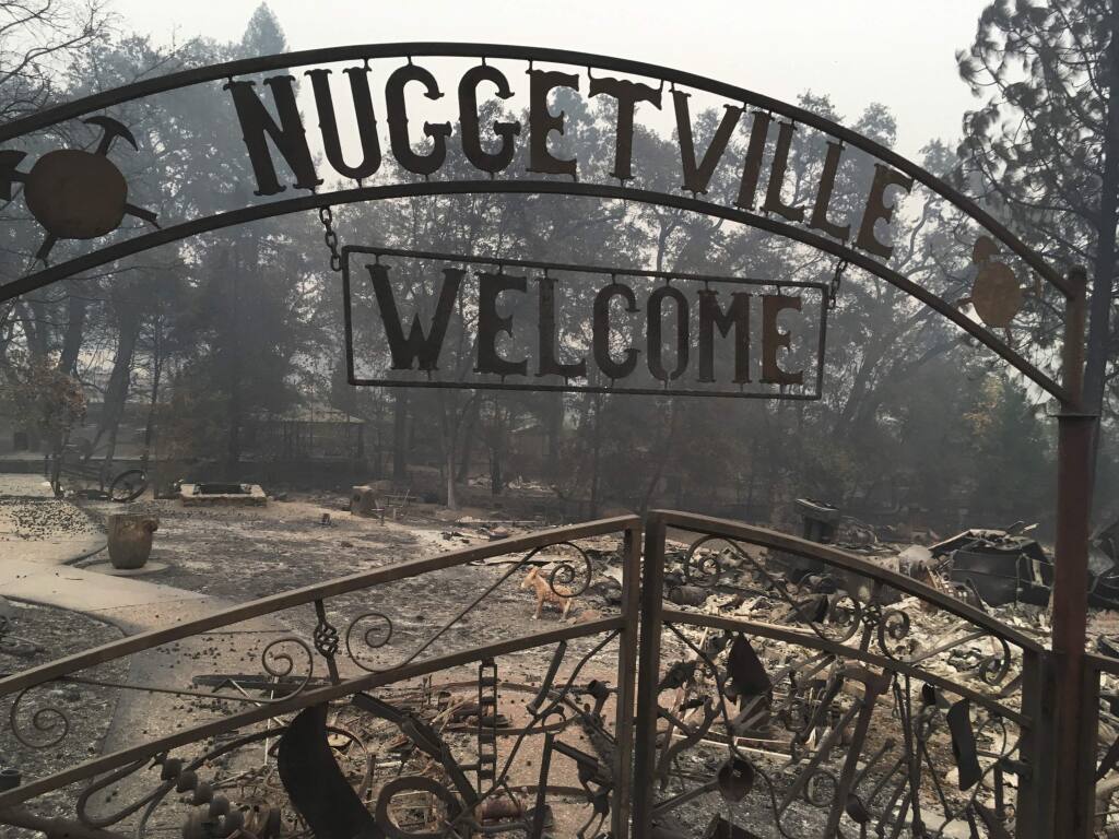 FILE - This Wednesday, Nov. 14, 2018 shows the remains of the Gold Nugget Museum, which was totally demolished by the Camp Fire, in Paradise, Calif. Paradise, Cali., literally went up in smoke in the deadliest, most destructive wildfire in California history. And memories are all that's left for many of the survivors. They recall a friendly place where the pace was relaxed, where families put down roots and visitors opted to stay. (AP Photo/Martha Mendoza, File)