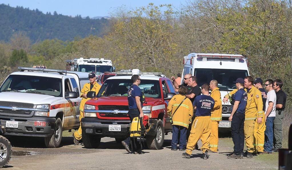Over a dozen firefighters and EMT's responded to a drowning along the Russian River, Friday Nov. 4, 2016 and were debriefed after the kayakers body was found. (Kent Porter / The Press Democrat) 2016