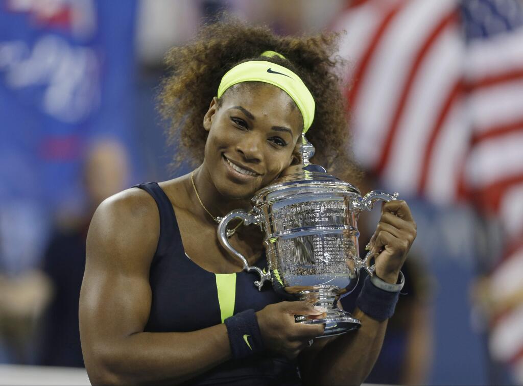 In this Sept. 9, 2012, file photo, Serena Williams holds the championship trophy after beating Victoria Azarenka in the championship match at the 2012 US Open in New York. (AP Photo/Mike Groll, File)
