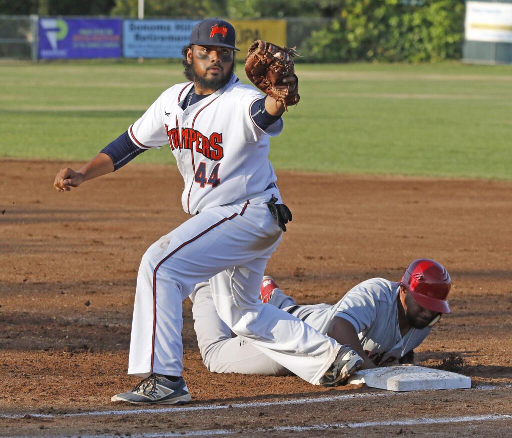 Bill Hoban/Index-TribuneSonoma Stomper Daniel Baptista grabs an errant pickoff throw during a recent game. Baptista hit a three-run homer in Wednesday's 8-3 win over Vallejo.