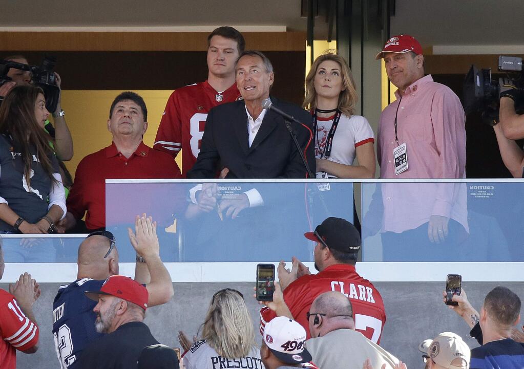 Former wide receiver Dwight Clark, center, speaks next to former San Francisco 49ers owner Edward DeBartolo Jr., left, during halftime of an NFL football game between the 49ers and the Dallas Cowboys in Santa Clara, Calif., Sunday, Oct. 22, 2017. (AP Photo/Eric Risberg)