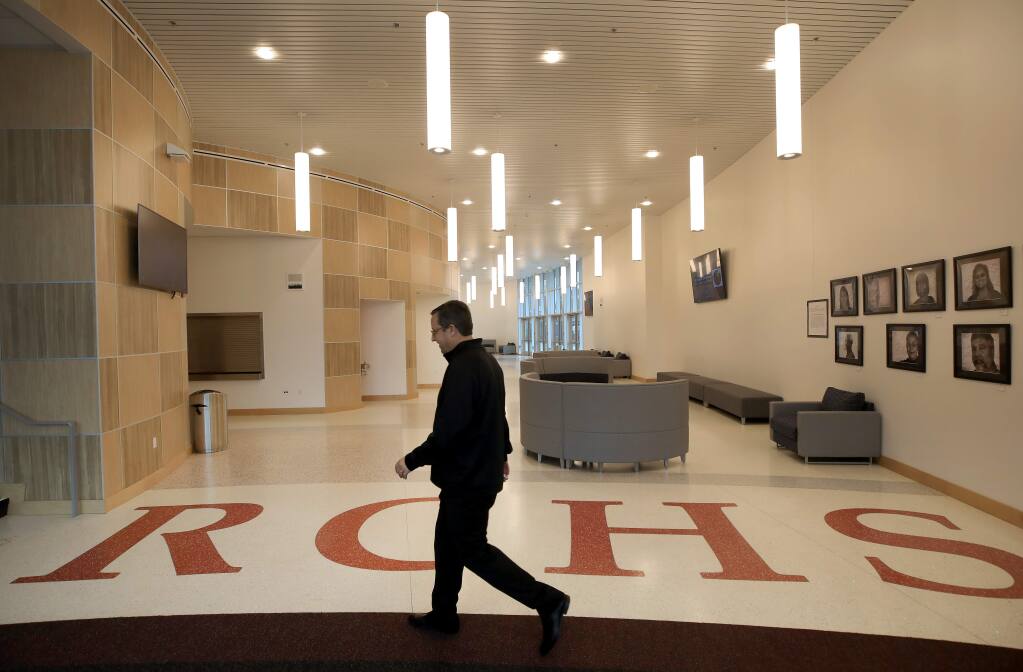 Rancho Cotate High School assistant principal Henri Sarlatte walks to open the theater doors, Thursday, Feb. 13, 2020, in a brand-new $52 million gymnasium and theater arts building on the campus in Rohnert Park. The gym is named after his father, Henry J. Sarlatte. (Kent Porter / The Press Democrat)