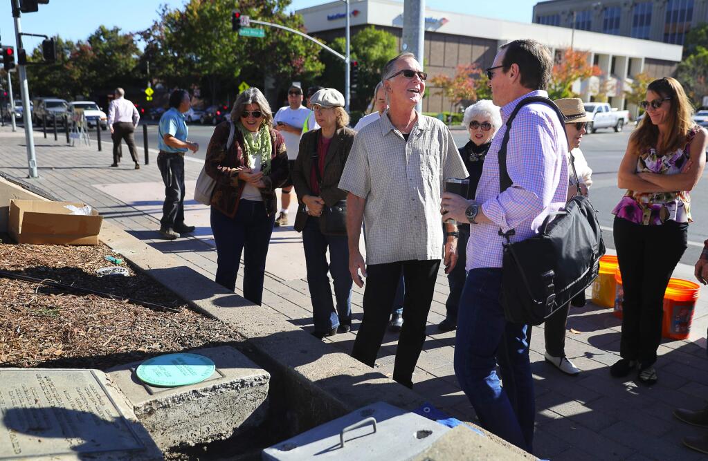 Santa Rosa City Council members John Sawyer, left, and Tom Schwedhelm, right, talk during the installation of a new bicentennial time capsule in Old Courthouse Square in Santa Rosa on Wednesday, November 7, 2018. Both Sawyer and Schwedhelm were re-elected to the city council Tuesday.(Christopher Chung/ The Press Democrat)