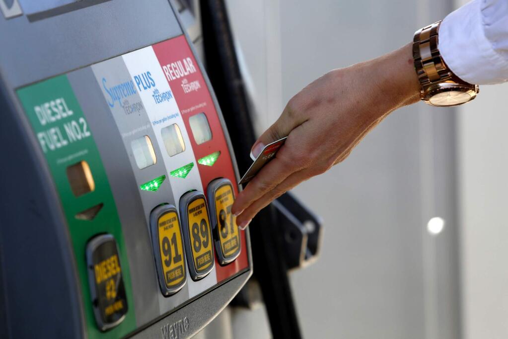 Selecting the fuel grade at the Chevron station on Aviation Boulevard, Santa Rosa. 2014. (Beth Schlanker/ The Press Democrat)