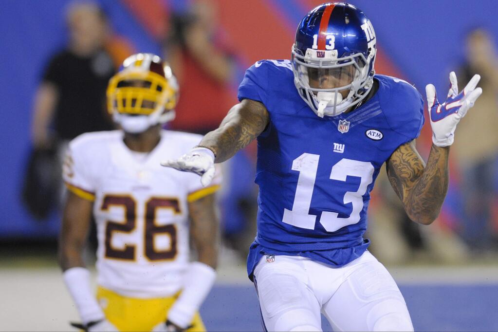 New York Giants wide receiver Odell Beckham (13) celebrates after catching a pass for a touchdown in front of Washington Redskins' Bashaud Breeland (26) during the second half an NFL football game Thursday, Sept. 24, 2015, in East Rutherford, N.J. (AP Photo/Bill Kostroun)