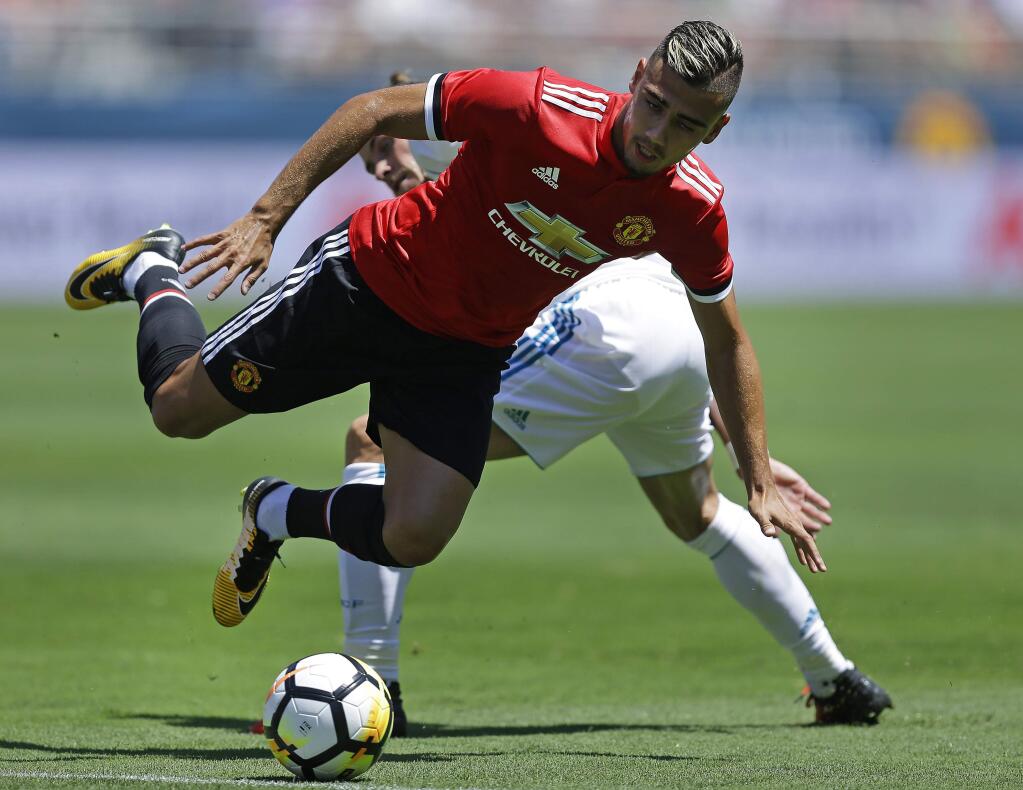 Manchester United's Andreas Pereira, front, and Real Madrid's Gareth Bale go for the ball during the first half of an international friendly soccer match Sunday, July 23, 2017, in Santa Clara, Calif. (AP Photo/Ben Margot)