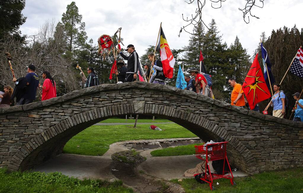 Participants in the Longest Walk cross over the bridge in Juilliard Park in Santa Rosa on Wednesday, Feb. 15, 2017. The walk, from San Francisco to Washington, D.C., is an effort to draw attention to substance abuse and domestic violence within Native American communities.(Christopher Chung/ The Press Democrat)