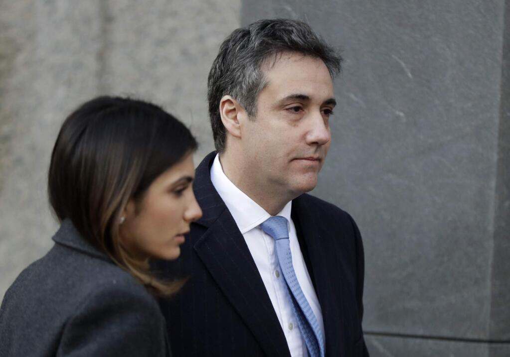 FILE - In this Dec. 12, 2018, file photo, Michael Cohen, right, President Donald Trump's former lawyer, arrives at federal court for his sentencing in New York. (AP Photo/Julio Cortez, File)