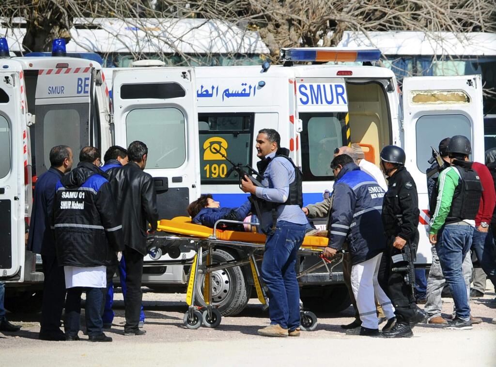 A victim is being evacuated by rescue workers outside the Bardo musum in Tunis, Wednesday, March 18, 2015 in Tunis, Tunisia. Gunmen opened fire at a leading museum in Tunisia's capital, killing at least eight people and wounding six, including foreign tourists, authorities said. A later raid by security forces left two gunmen and one security officer dead but ended the standoff, Tunisian authorities said. (AP Photo/Hassene Dridi)