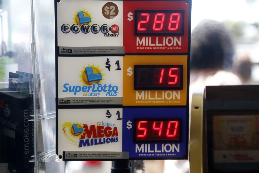 FILE - In this July 8, 2016 file photo, an electronic sign at Bluebird Liquors in Hawthorne, Calif., displays lottery jackpots. (AP Photo/Nick Ut, File)