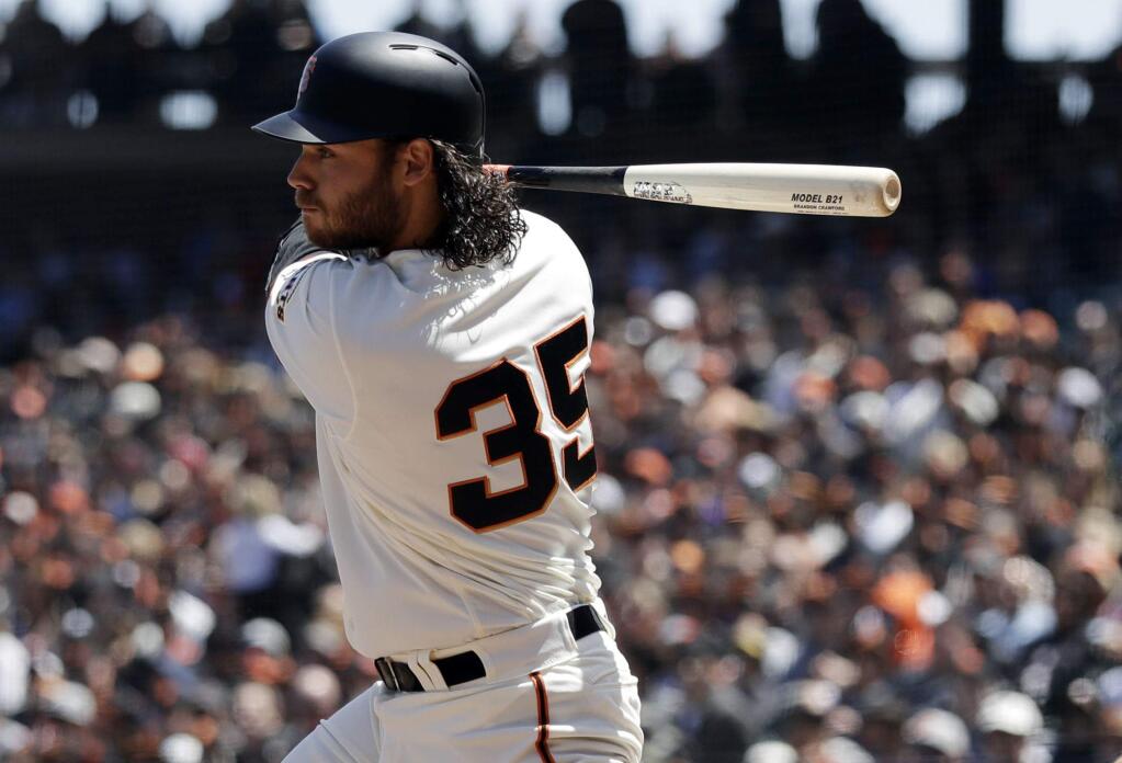 The San Francisco Giants' Brandon Crawford drives in two runs with a double during the third inning against the Colorado Rockies, Saturday, May 19, 2018, in San Francisco. (AP Photo/Marcio Jose Sanchez)