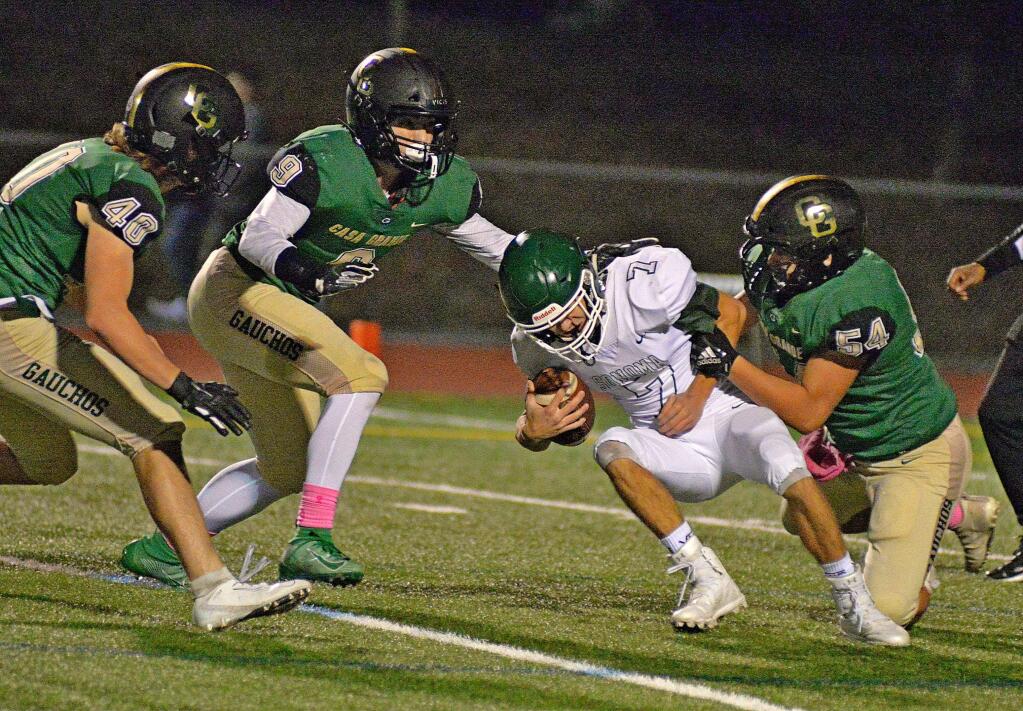 SUMNER FOWLER/FOR THE ARGUS-COURIERCasa Grande's Logan Walsh (40), Aaron Junnila (9) and Marc Lopez (54) surround Sonoma Valley quarterback Jake Baker.