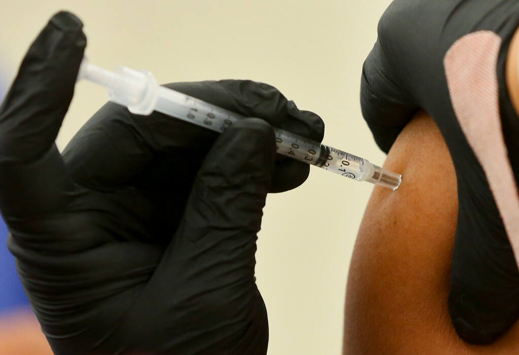 Medical assistant Ashley Simpson administers a dose of the Pfizer-BioNTech COVID-19 vaccine at the Fox Home Health vaccination clinic in the Roseland area of Santa Rosa on Thursday, August 26, 2021.  (Christopher Chung/ The Press Democrat)