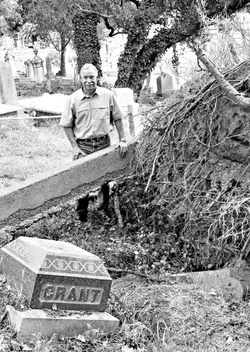 ann carranza / For TownsJim Dreisback stands next to a tree that fell in Oak Mound Cemetery, disturbing gravesites.