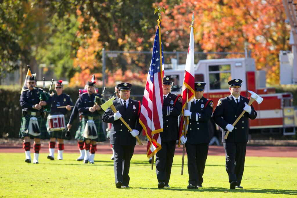 The Fire Department color guard followed by the California Firefighter Pipe and Drum Band opened the Sonoma County Day of Remembrance on SRJC's Bailey Field on Saturday, October 28, 2017. (photo by John Burgess/The Press Democrat)