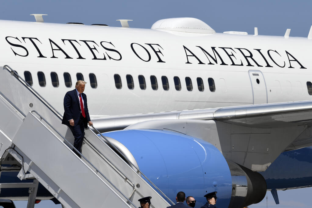 President Donald Trump exits Air Force One as he arrives at Burke Lakefront Airport in Cleveland, Ohio, Thursday, Aug. 6, 2020. (AP Photo/Susan Walsh)