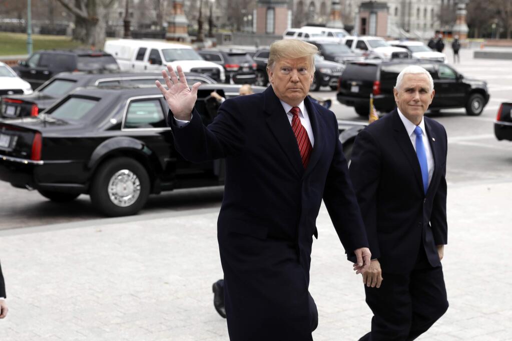 In this Jan. 9, 2019, photo, President Donald Trump arrives with Vice President Mike Pence to attend a Senate Republican policy lunch on Capitol Hill in Washington. (AP Photo/ Evan Vucci)