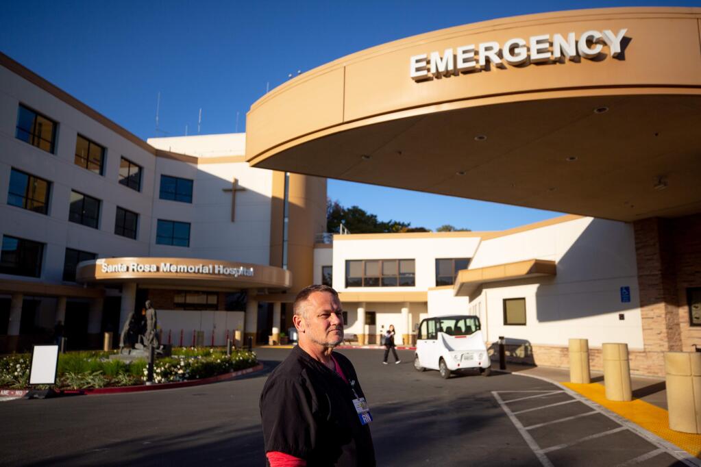 Emergency department charge nurse Todd Axberg waits for a patient's arrival in front of Santa Rosa Memorial Hospital during the Kincade Fire in Santa Rosa, California, on Friday, November 1, 2019. (Alvin Jornada / The Press Democrat)