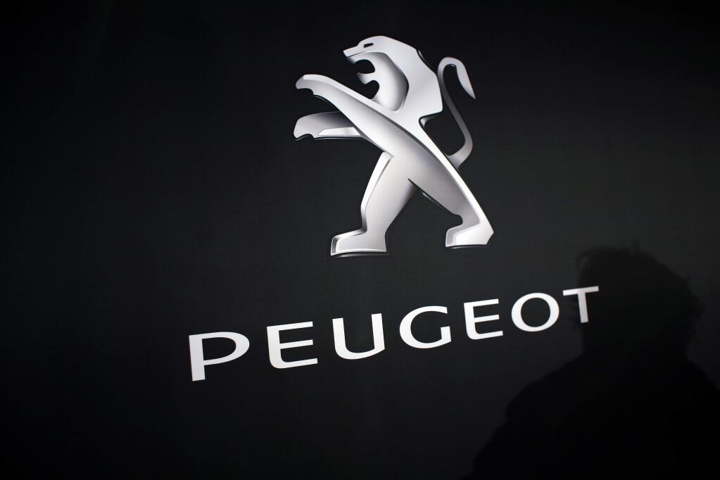 In this March 1, 2018 photo, the logo of Peugeot is displayed at PSA Peugeot Citroen headquarters during the presentation of the company's 2017 full year results, in Rueil-Malmaison, west of Paris, France. Italian-American carmaker Fiat Chrysler Automobiles on Wednesday, Oct. 30, 2019 confirmed that it is in talks with French rival PSA Peugeot, its second bid this year to reshape the global auto industry facing huge challenges with the transition to electric and autonomous vehicles. (AP Photo/Thibault Camus)