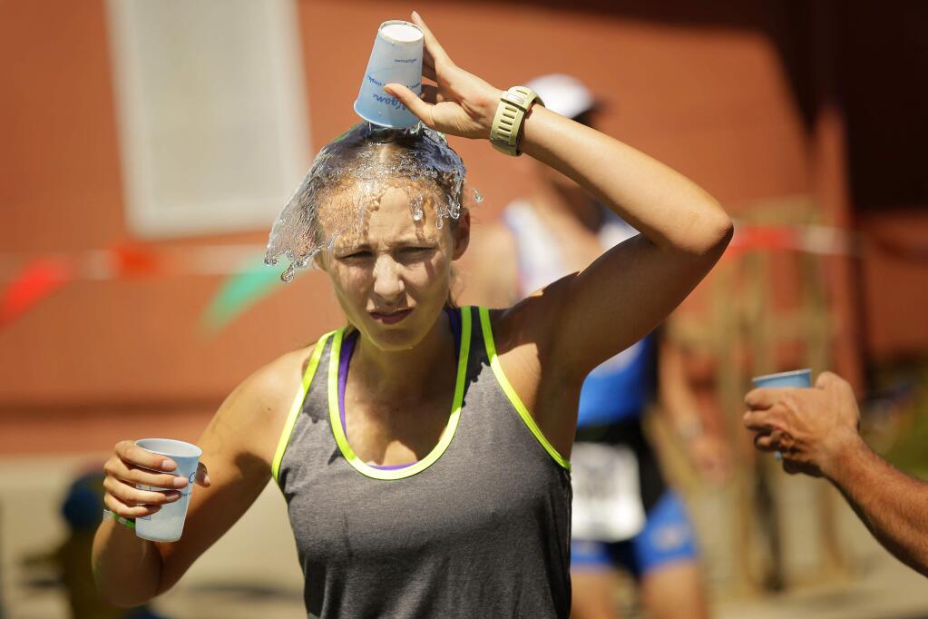 Triathletes try to cool down while competing in the final running section of the Vineman Triathlon in Windsor on Friday, July 18, 2014. (Conner Jay/The Press Democrat)