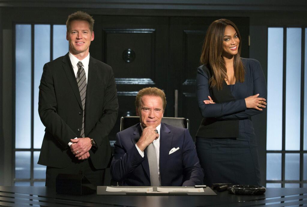 This image released by NBC shows, from left, Patrick Knapp Schwarzenegger, Arnold Schwarzenegger and Tyra Banks from 'The New Celebrity Apprentice,' in Los Angeles. Schwarzenegger is the latest victim of a Donald Trump Twitter attack. The president-elect took time Friday to note that the 'Terminator' star was 'swamped' in his 'Celebrity Apprentice' debut 'by comparison to the ratings machine, DJT.' Trump is right about the ratings, using the comparison he set up. His Jan. 4, 2004 debut on the reality show drew 18.49 million viewers, and Schwarzenegger's Monday bow as host was seen by 4.95 million. However, television shows almost always fade in popularity with time, and live viewership in general is down in an on-demand world. (Luis Trinh/NBC via AP)