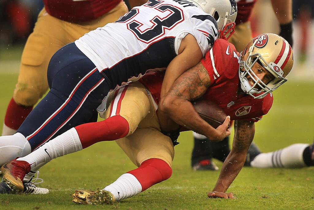 San Francisco QB Colin Kaepernick is sacked by Kyle Van Noy in the first quarter during the Patriots' 30-17 victory at Levi's Stadium in Santa Clara, Sunday Nov. 20, 2016. (Kent Porter / The Press Democrat)