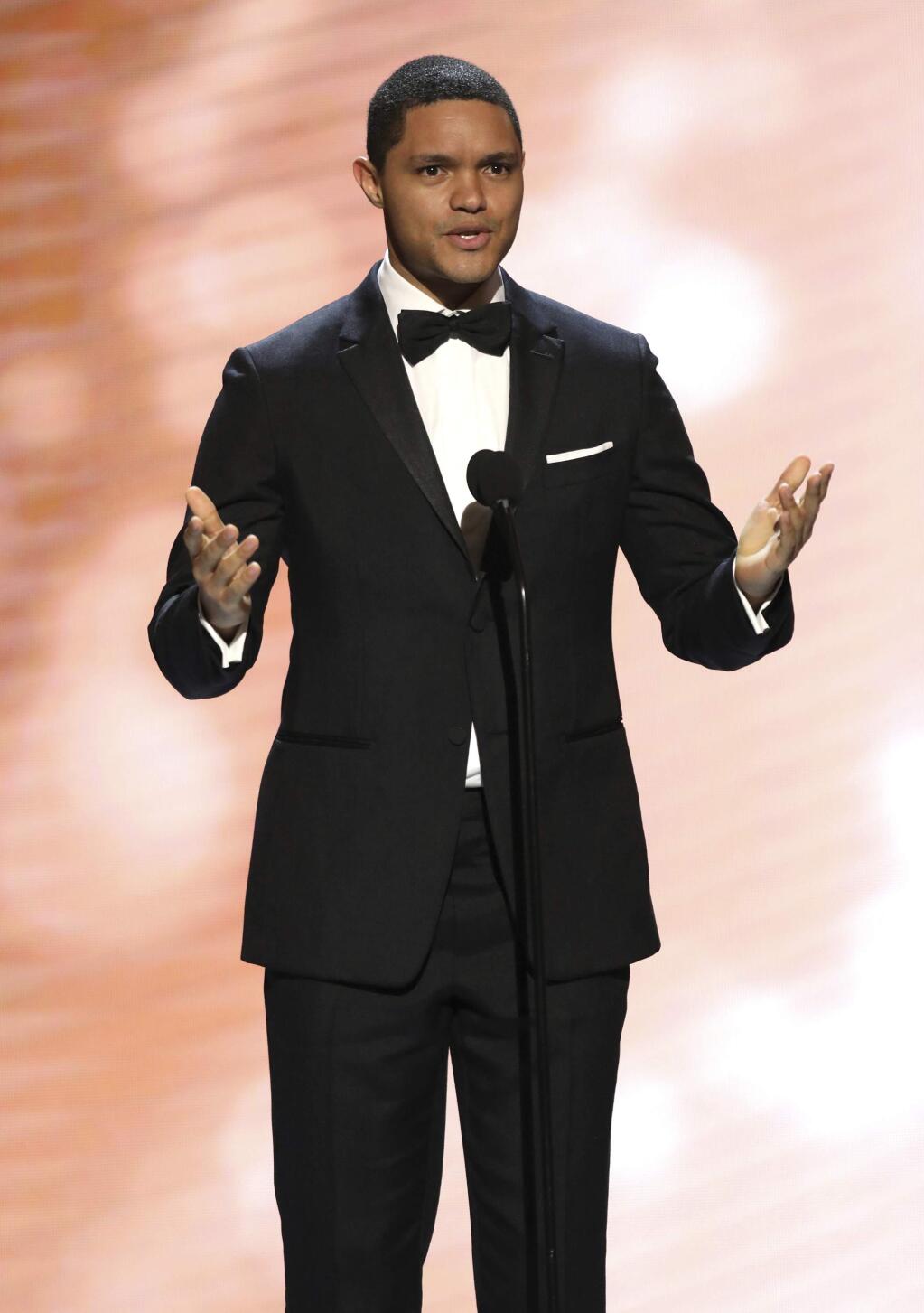 FILE - In this Feb. 11, 2017, file photo, Trevor Noah presents the award for outstanding actress in a comedy series at the 48th annual NAACP Image Awards at the Pasadena Civic Auditorium in Pasadena, Calif. Late-night comics decried the Las Vegas mass shooting as a confoundingly repetitive American tragedy, with Jimmy Kimmel and Noah lashing out at politicians who oppose gun control. They spoke out on Monday, Oct. 2, the day after the worst shooting in modern U.S. history. (Photo by Matt Sayles/Invision/AP, File)