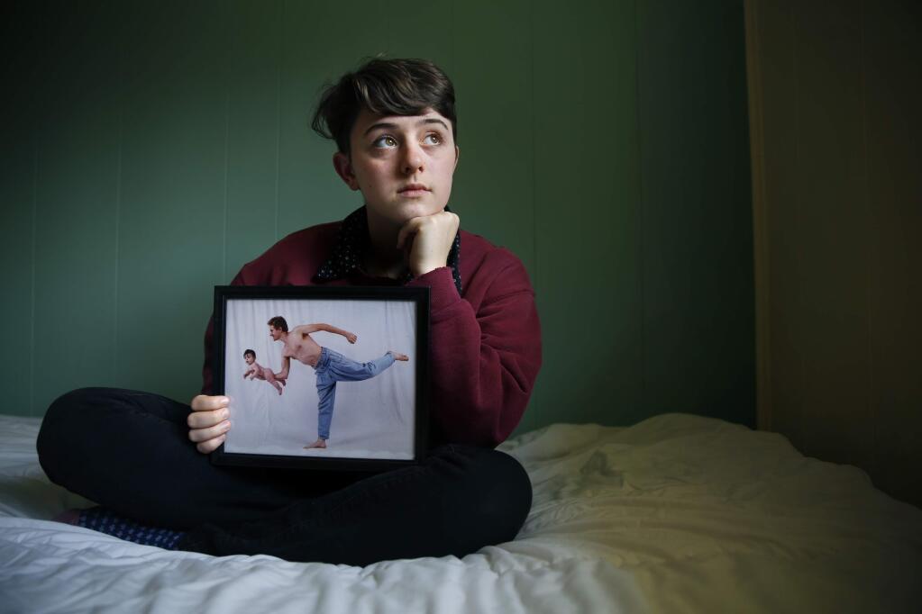 Siobhan O'Reilly, 18, holds a photo of her father, Daniel, and herself as a baby. O'Reilly recently visited the prison at San Luis Obispo to meet Michael Albertson, the man who killed her father in a drunk driving accident 11 years ago. Photo taken at her home on Thursday, May 21, 2015 in Sonoma, California . (BETH SCHLANKER/ The Press Democrat)